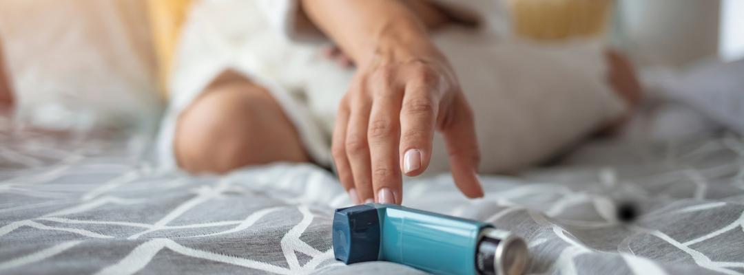 person reaching for inhaler