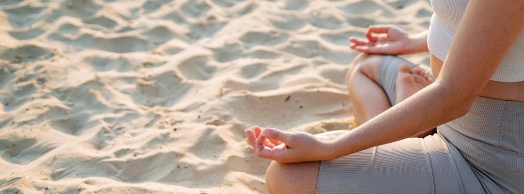 A woman is peacefully sitting in a traditional lotus position