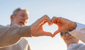Liebe macht das Herz zum Frieden. Älteres älteres Paar, das mit den Händen Herzform annimmt. Erwachsener alter Ehemann Frau zeigt Herzzeichen. Glückliche Rentnerfamilie. Ich liebe dich glücklich Valentinstag
